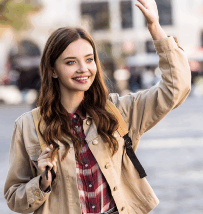 young woman smiles and waves at neighbor